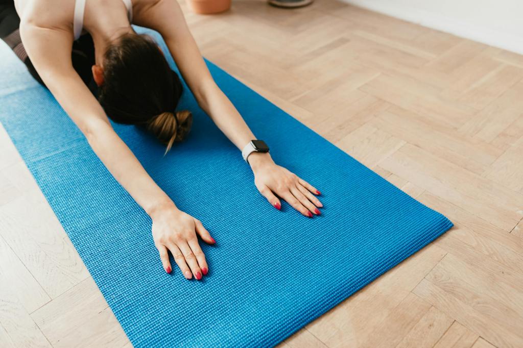 Woman in childs pose on yoga mat